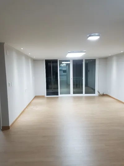 확장 후 바닥과 창을 새로 한 빈 거실